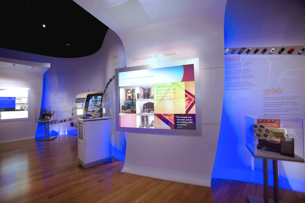 NED_Qualcomm-Museum_06_Wave-Wall-with-Graphics,-Artifacts-in-Cabinets,-and-Micro-Tile-Displays